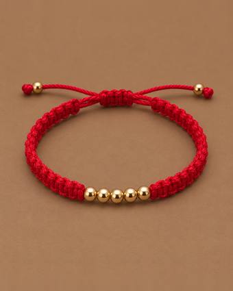 Pulsera tejida roja con cinco balines de oro